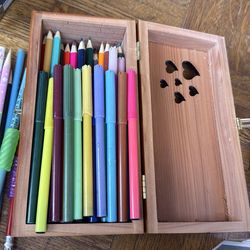 Wooden box with colored pencils and markers