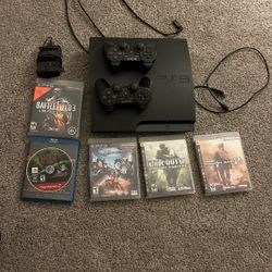 PS3 With 2 Controllers, Games, A Charger, And Charging Station