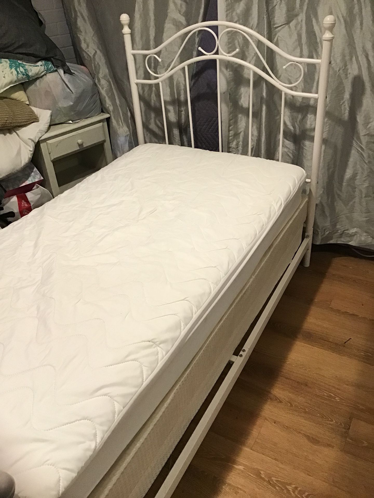White twin bed with box spring and mattress