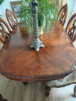 Ornate carved wood dining table and 8 chairs