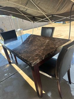 Marble table with 3 dark brown chairs