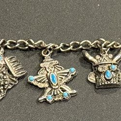 Native American themed bracelet with 6 assorted charms. one charm missing a stone as shown (circled in photo). 7” length 
