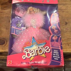 Superstar Barbie" doll from 1988, still in its original packaging. This Barbie is identified as the "Award-Winning Movie Star" version, model number 1