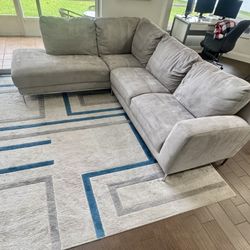 L-shape couch and area rug. Left chaise facing. Couch is 108 inches wide and 90 inches in length.
