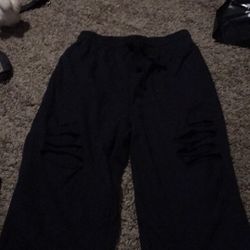 Black Sweats They Are Designed With A Few Holes In Them 