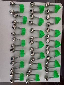 dual fishing bite alarms with spring clip, green and silver-colored
