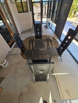 glass table with four chairs