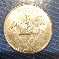 1999 delaware quarter with horses spit on it