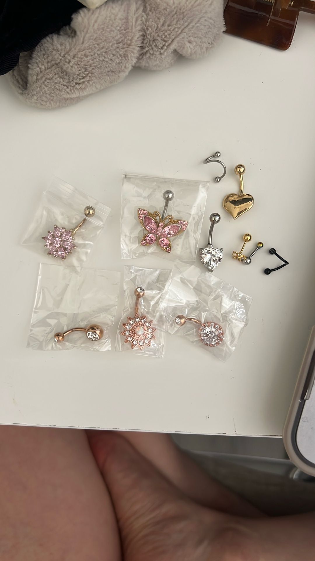 9 Belly button Rings + 2 Ear Piercings