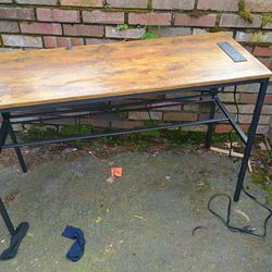 A desk with four plugins and two USB ports