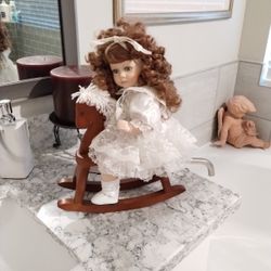 Porcelain Doll On Wooden Horse