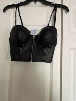 . . It’s very cute top. It’s brand new it’s leather. The color is black. The size is XS