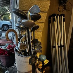 Antique golf clubs, golf balls, and bag