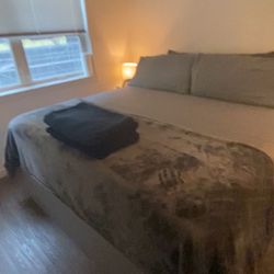 King Size Bed With Pillows And Side tables And Lamps 
