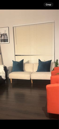 Cream upholstered couch convert to full size