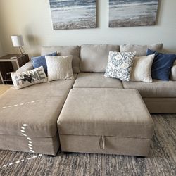 Beige fabric couch and ottoman set