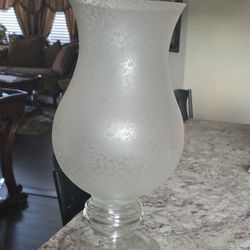 This is a clear frosted glass hurricane lamp or candle holder. 