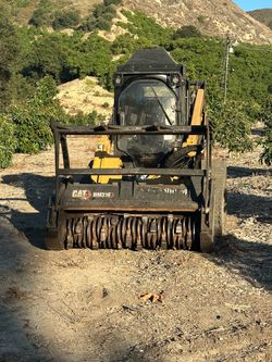 Caterpillar skid steer tractor mulcher