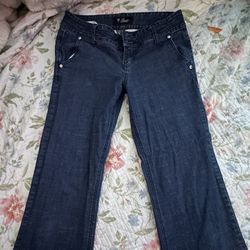 Guess?  Woman’s dark washed flared low rise jeans 