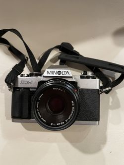 Minolta XG-1 35mm SLR film camera with a 45mm f/2 lens and UV filter.