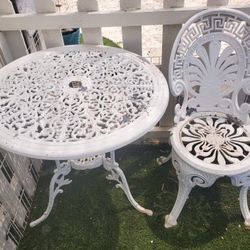 Two piece white metal wrought iron set. Set includes one chair and one table. They are both structurally stable 