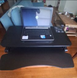 Adjustable Vari Desk Allows you to stand at your desk, or as seen in the picture adjust back to seat level. Excellent in condition