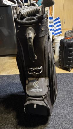 Cleveland golf bag new and a putter plus used clubs old