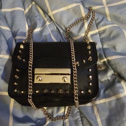 This item is a Furla Julia Mini Studded Saffiano Leather Crossbody Bag in black. 