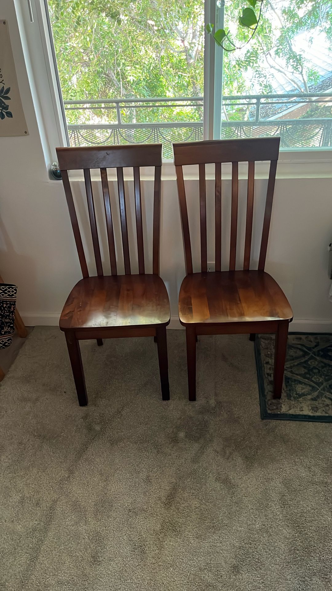 Two Dark Brown Wooden Chairs