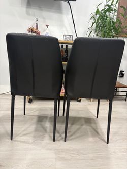 Two black dining chairs