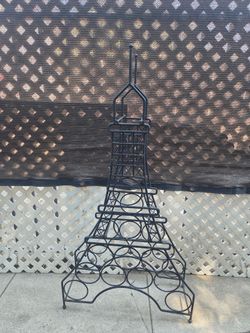 Eiffel Tower wine rack sold AS IS has rust and its uneven