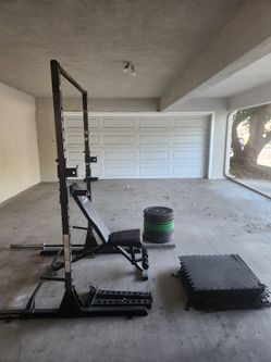 Squat Rack with 190 lbs of weights, bench, barbells, and dip bars