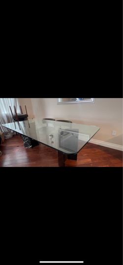 Glass dining table with marble legs