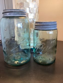 Set of 2 antique Ball slope shoulder Mason jars with zinc milk-glass lined lids (quart and pint) both have bubbles which increase their value because 