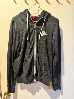 Nike zip-up hoodie with full front zipper. Drawstring hood and front pockets. Nike swoosh logo on chest. Casual layering piece for everyday wear.  Siz