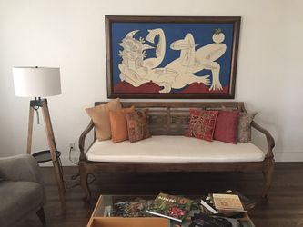 Pre-owned hand carved wood bench from Indonesia with cushions included. 