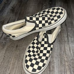 Black and white checkered Vans slip-ons