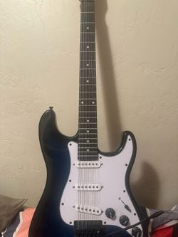 Electric guitar comes with cable and fender