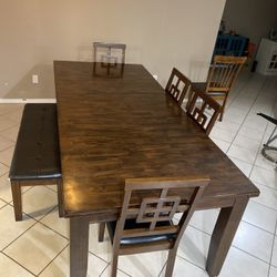 Brown dining table with chairs