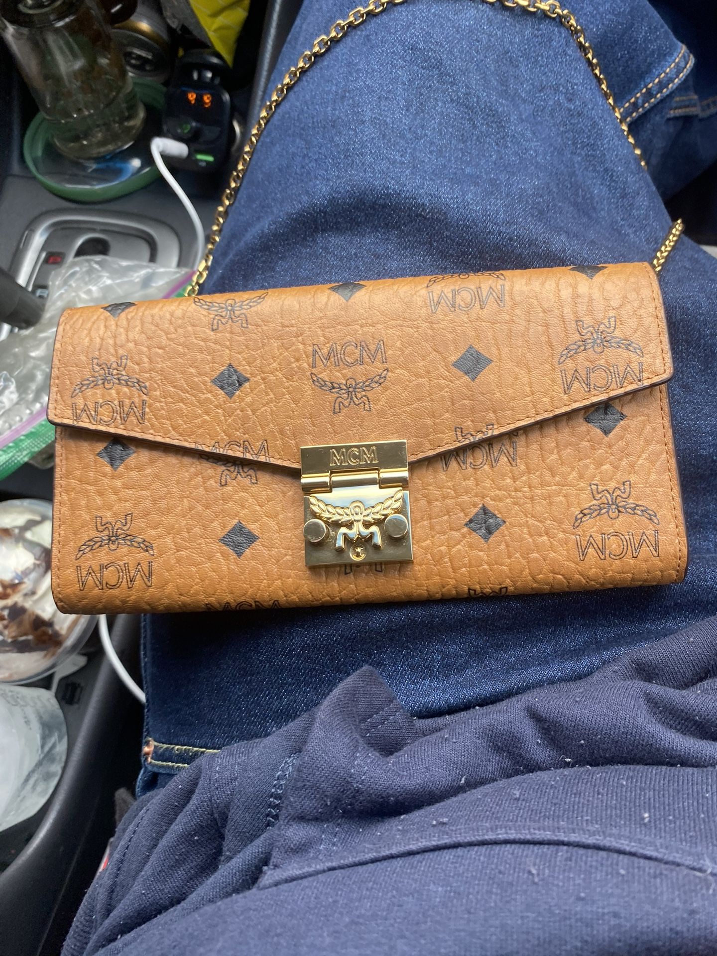 MCM clutch with hidden strap