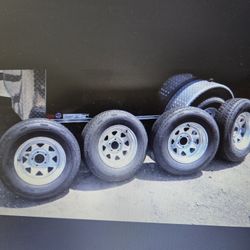 BRAND NEW FOUR ( 4 ) BOAT TRAILER TIRES AND GALVANIZED RIMS.