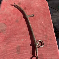 The object is an antique metal horse harness hames, which are part of a horse collar harness.  