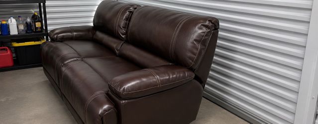 Hardly used Brown Faux Leather Reclining Loveseat