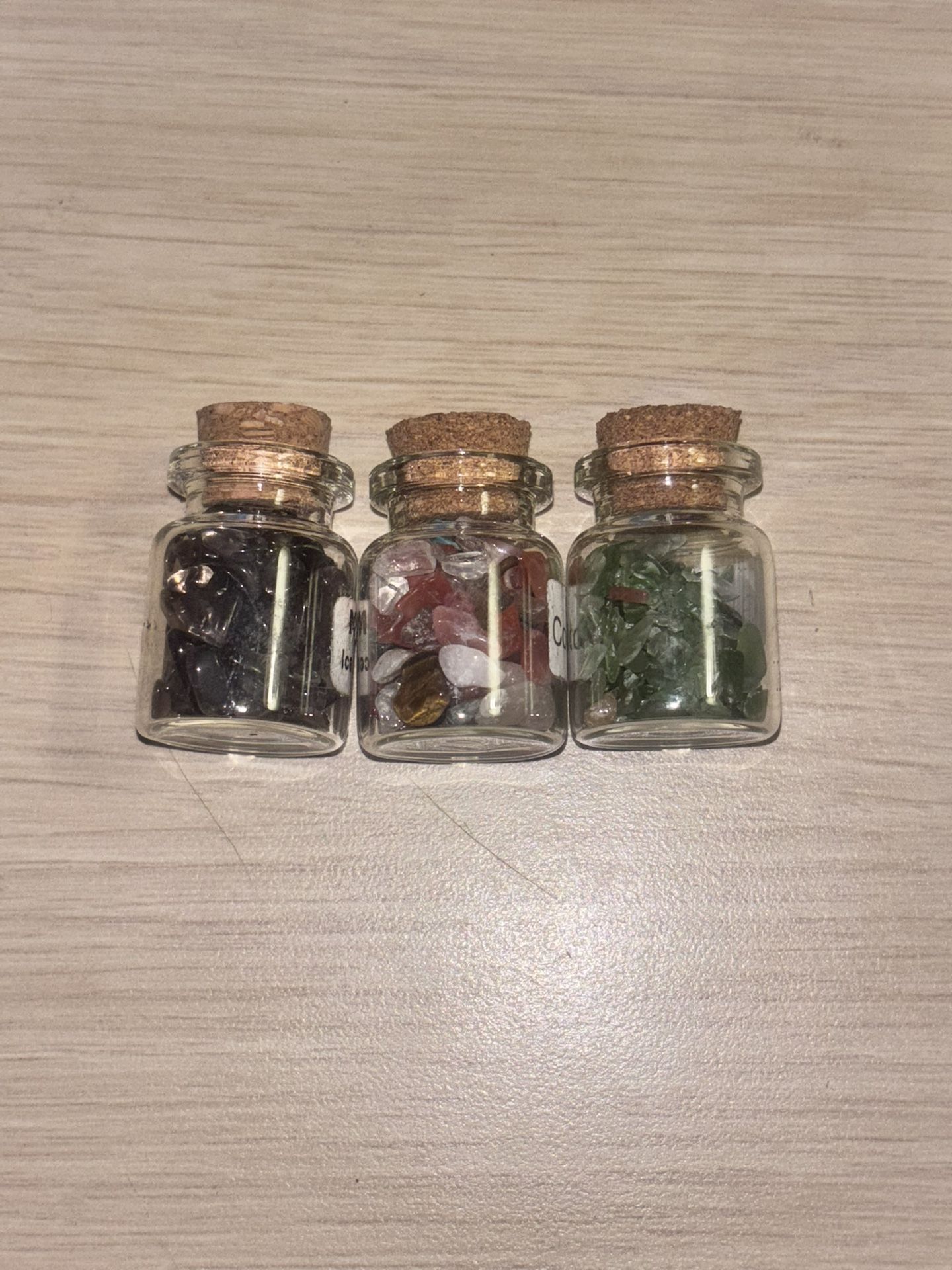 Three Glass Jars Of Gemstones