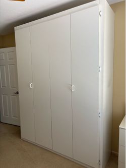 Queen sized Murphy bed in white cabinet