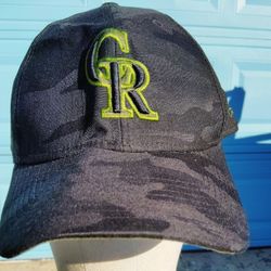 Colorado Rockies MLB Armed Forces Day 39THIRTY flex fit hat in a black and green camo colorway. 