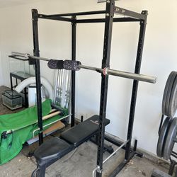Titan Power Rack, Olympic Bar, And 320lbs Of Weight With Racks Included