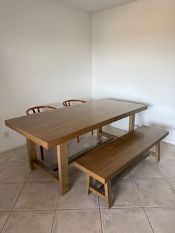 Solid wood trestle-style dining table with matching bench, purchased from City Furniture (Vail Light