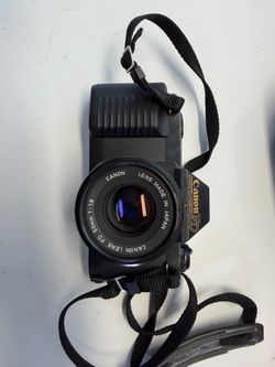 Canon T50 film camera is equipped with a 50mm f/1.8 FD prime lens