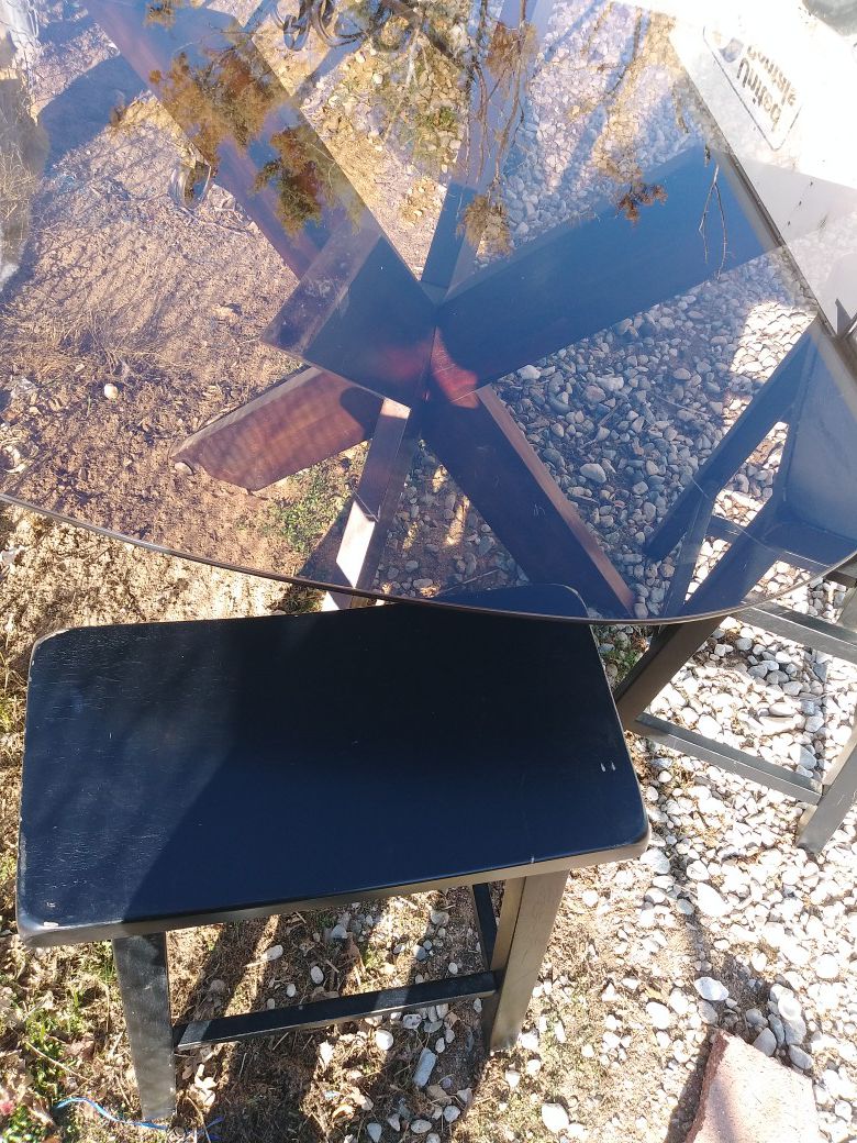 Smoke glass table with 4 made in malaysa wooden black stools $80. No holds